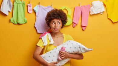 mother care concept ethnic mom holds new born child wrapped blanket busy nursing baby home being maternity leave enjoys intimate moment with small daughter babysitter with infant