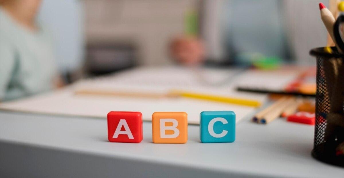 front view letters cubes with defocused tutoring session back 23 2148524531 1
