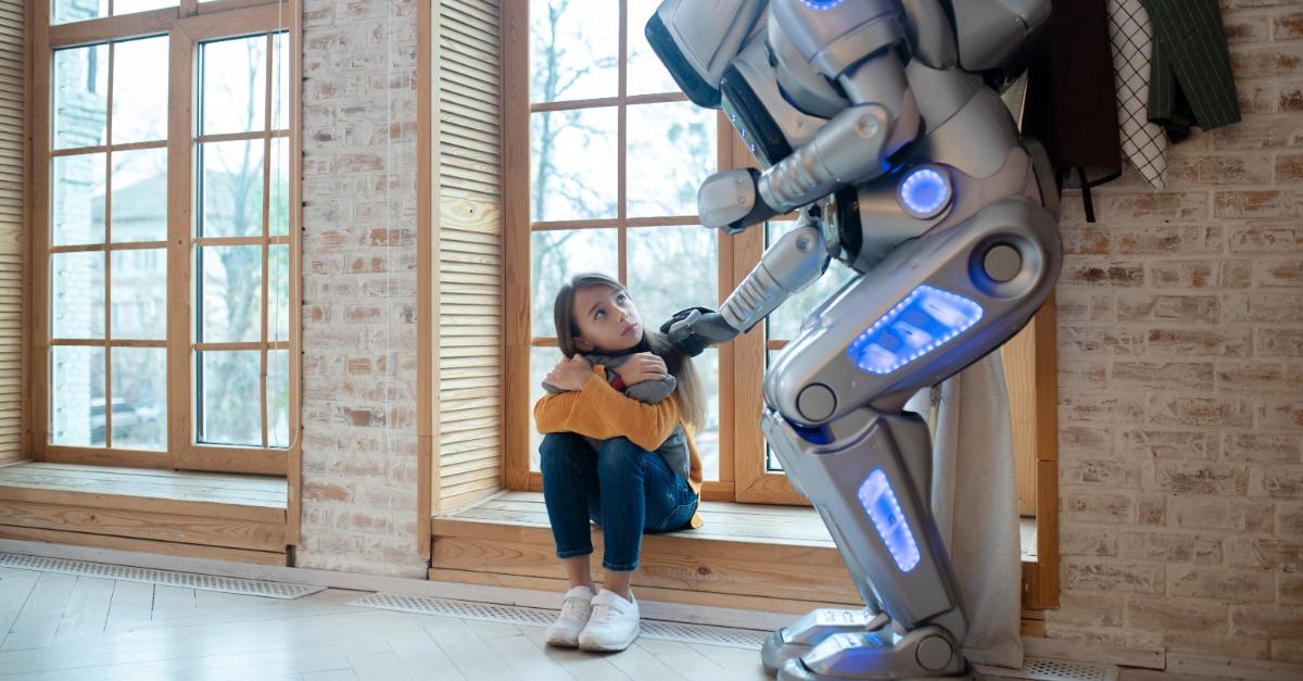 Good friend. Big house robot touching girls shoulder tenderly while talking to her