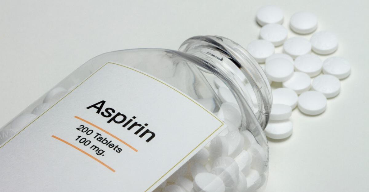 aspirin bottle fallen over with pills