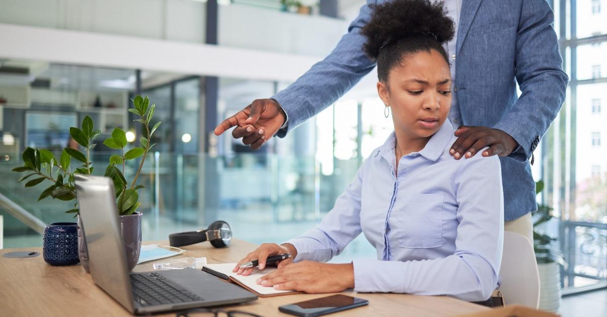Workplace harassment sexual abuse and unprofessional behavior from manager and business man touching a coworker in an office