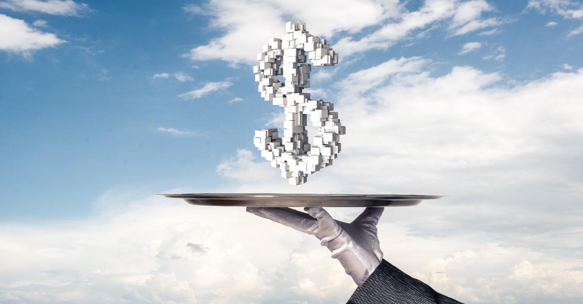 Cropped image of waitresss hand in white glove presenting multiple cubes in form of dollar sign on metal tray with cloudy skyscape on background