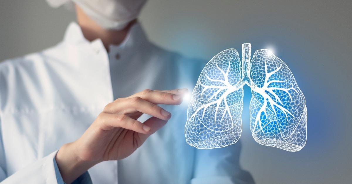 Female doctor touches virtual Lungs in hand