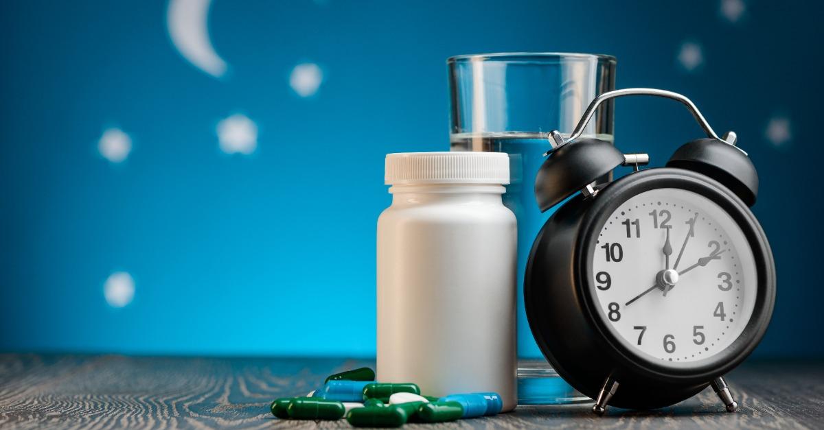 Sleeping pills water and clock