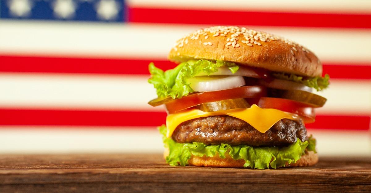 Close up home made burger on wooden table over USA flag background