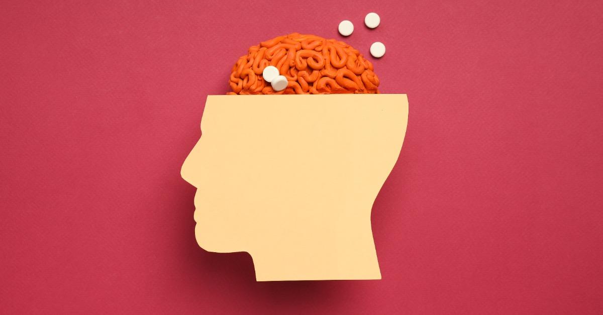Paper head with decorative brain on red background
