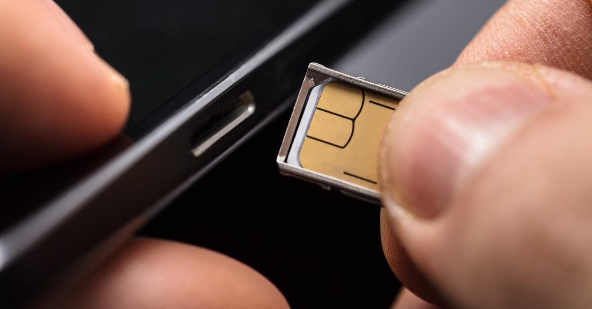 Close up Of A Person Inserting A Sim Card Into The Back Of A Mobile Phone