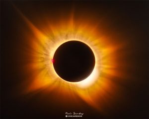 太陽變金色了?日全食驚見「黃金日冕」 NASA揭開罕見天象真相 1 西班牙日全食期間,太陽日冕罕見呈現金黃色。由於太陽接近地平線,陽光穿過較厚的大氣,加上附近森林火災煙霧進一步散射藍光,使金色調更加明顯;太陽左側的氫發光日珥則維持亮粉紅色。(圖/NASA)